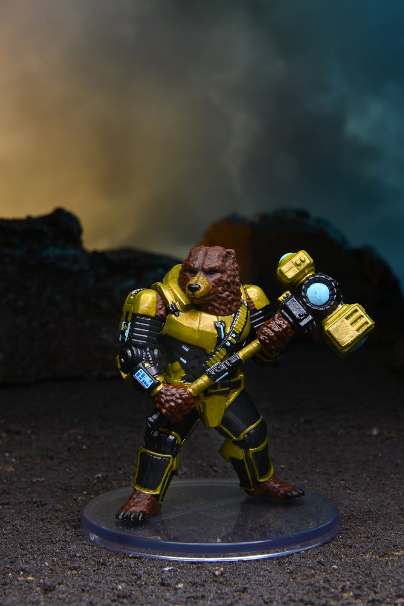 Mini figure of an uplifted bear in gold and black armor, wielding a large hammer