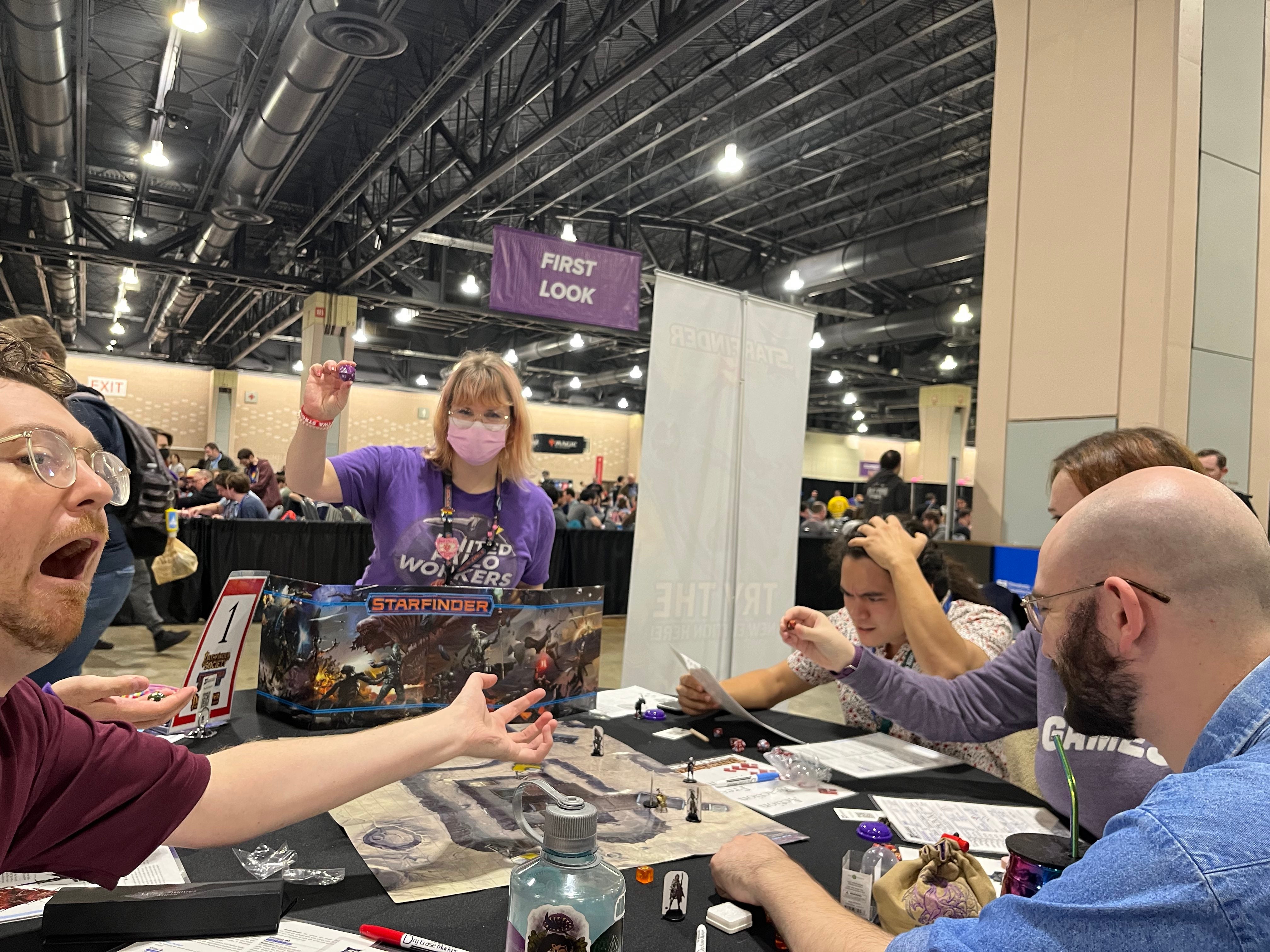 A group of players sitting around a table at the PAX unplugged convention