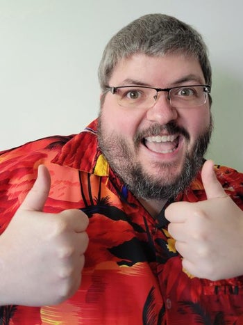 Thurston Hillman headshot while giving two thumbs up