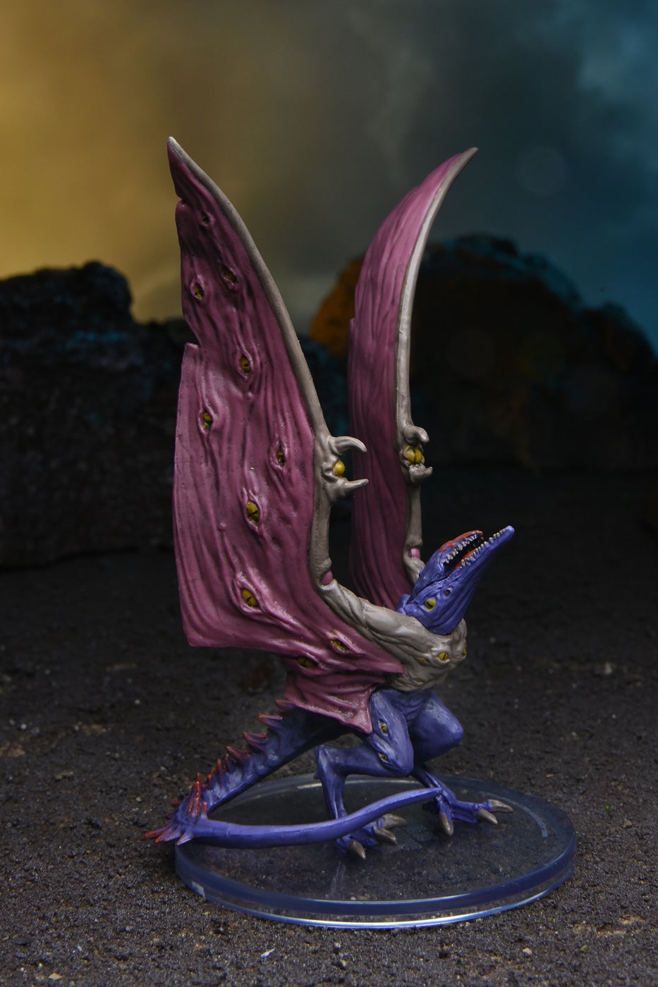 Mini figure of a Sharpwing, a purple, winged, alien, covered in yellow eyes
