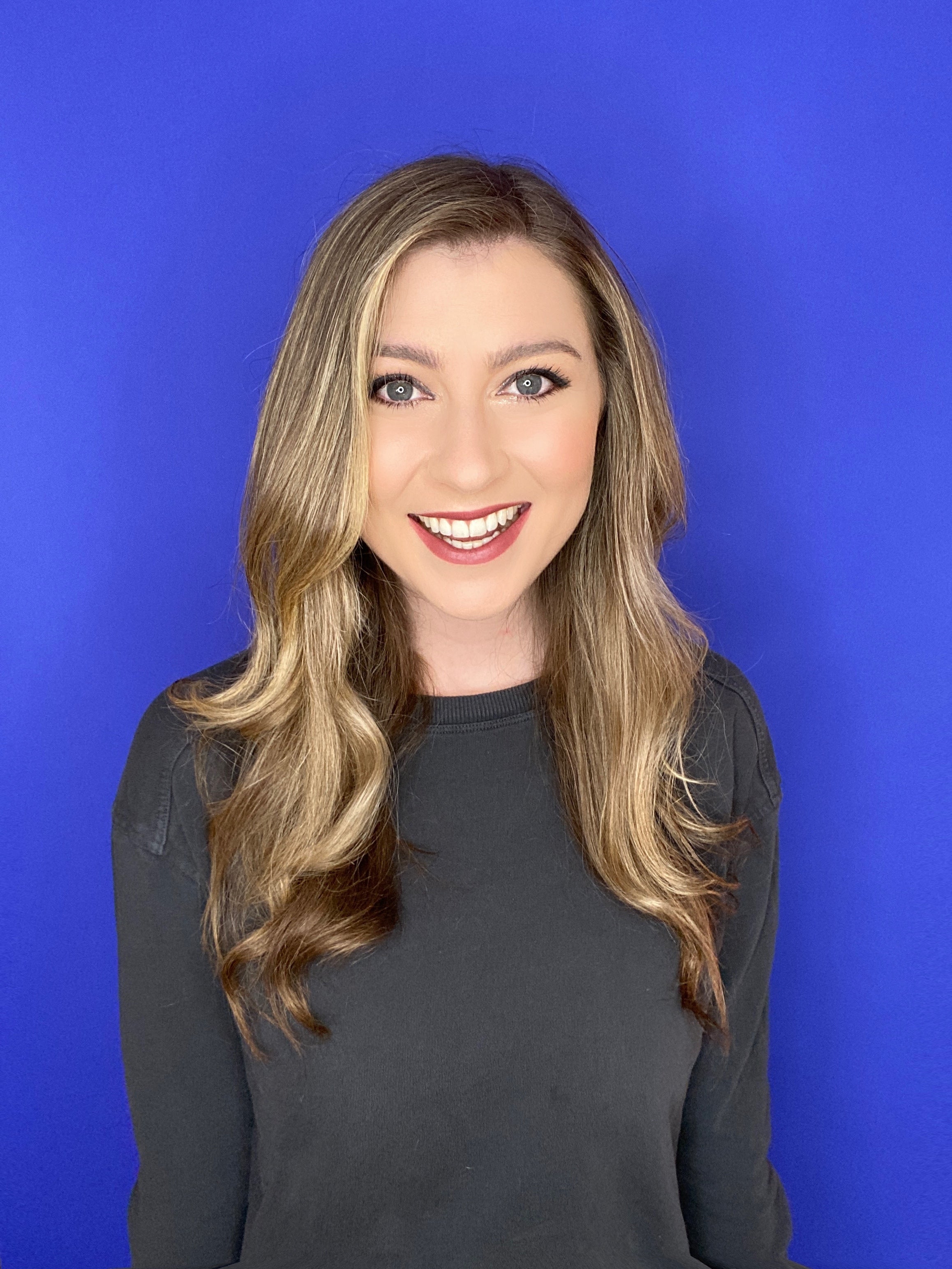 Headshot of Katie Wilson in front of a blue background