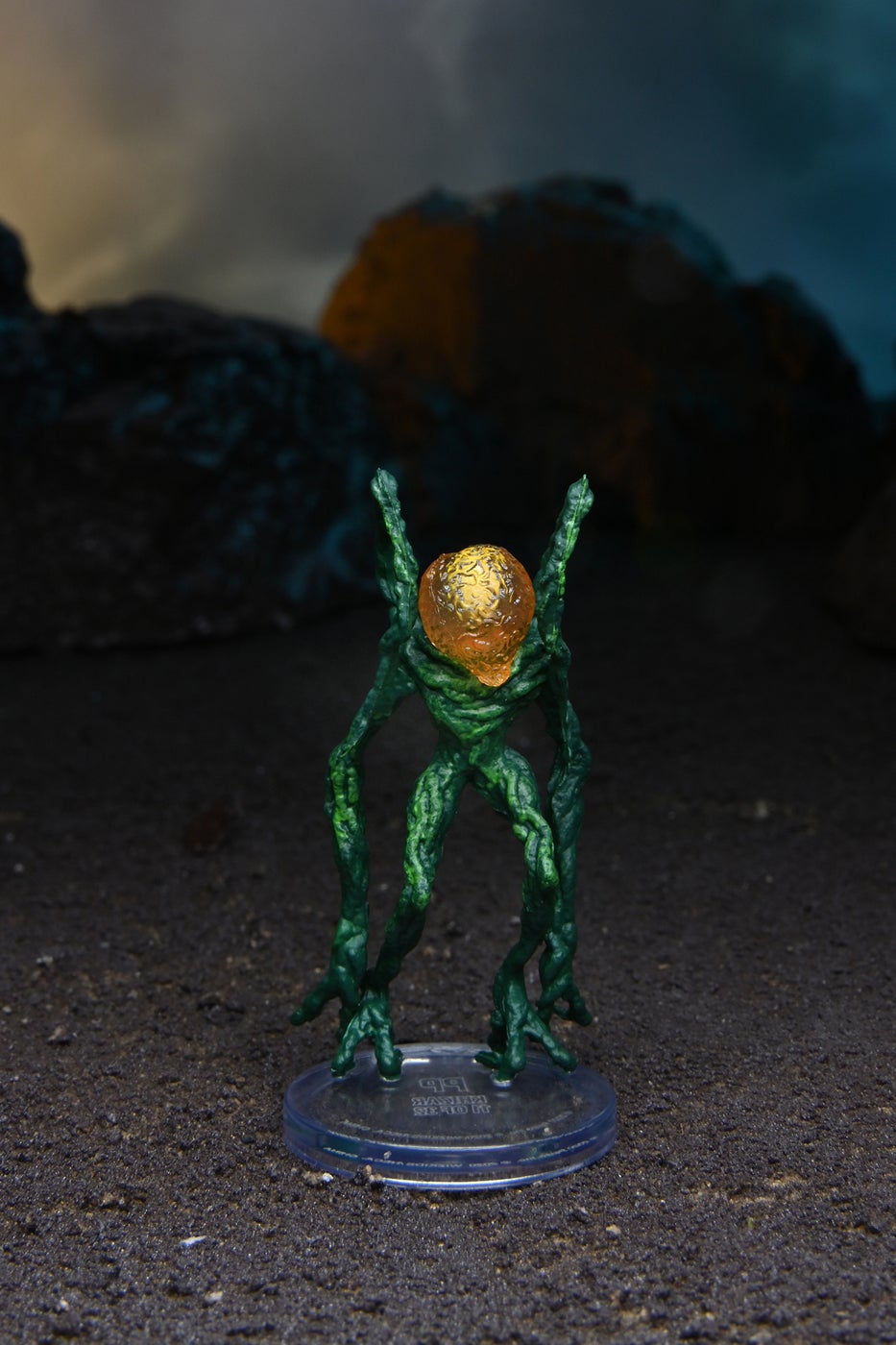 Mini figure of a Khizar, a two legged plant-like alien with a large yellow head