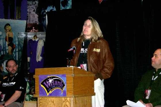 Lisa Stevens standing at a podium giving a speech