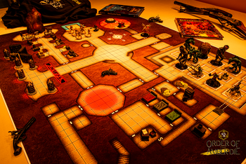 A top down view of a square tiled map with mini figures