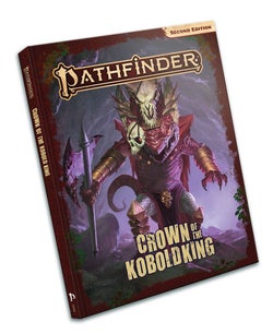 Pathfinder Adventure: Crown of the Kobold King. A red kobold approaches the viewer, wearing a skull crown, gold vambraces, carrying a bloody axe