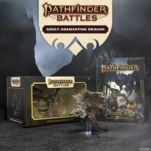 Pathfiner Battles Adult Adamantine Dragon Miniature promo photo. A staged photo of an unboxed, painted adamantine dragon miniature, the box containing the miniature, and a copy of Pathfinder Second Editon Remastered Monster Core hard cover in the background.