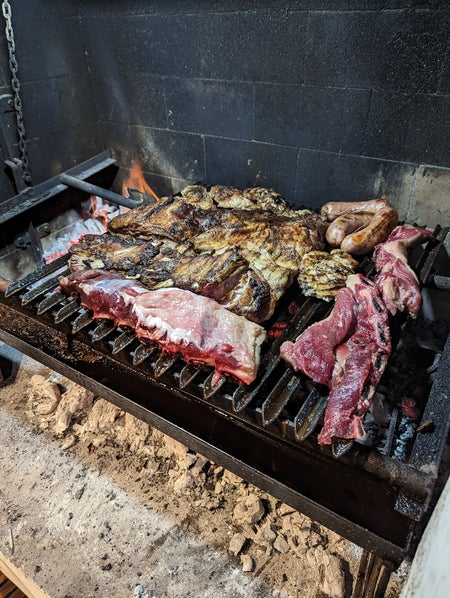 A picture of asado being grilled.