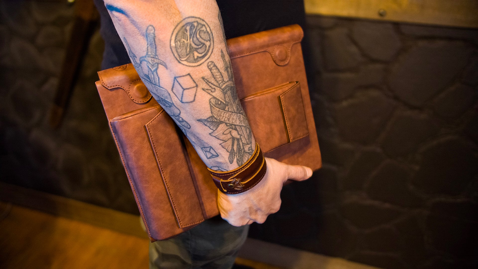 A picture of a person carrying the folded up screen under their arm