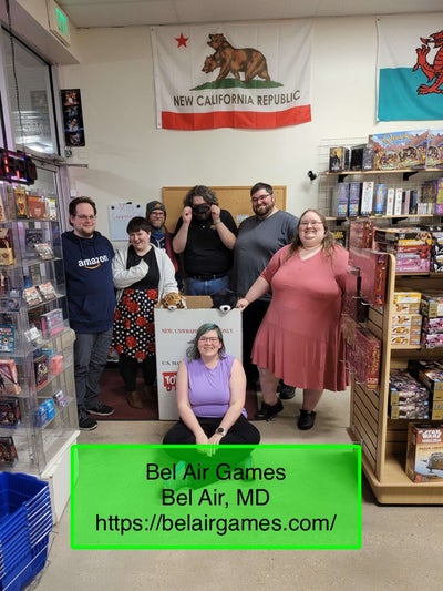 Photo Credit: Ryan Youngbar - a group of volunteers stand around a charity toy bin in the game shop, Bel Air Games in Marylan
