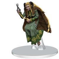 Norn Mini Figure: a yellow eyed being with long blond braids and a brown furred cloak, holding a spindle and scissors