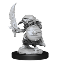 Mini figure of a goblin fighter, crouched behind a shield with a jagged sword raised
