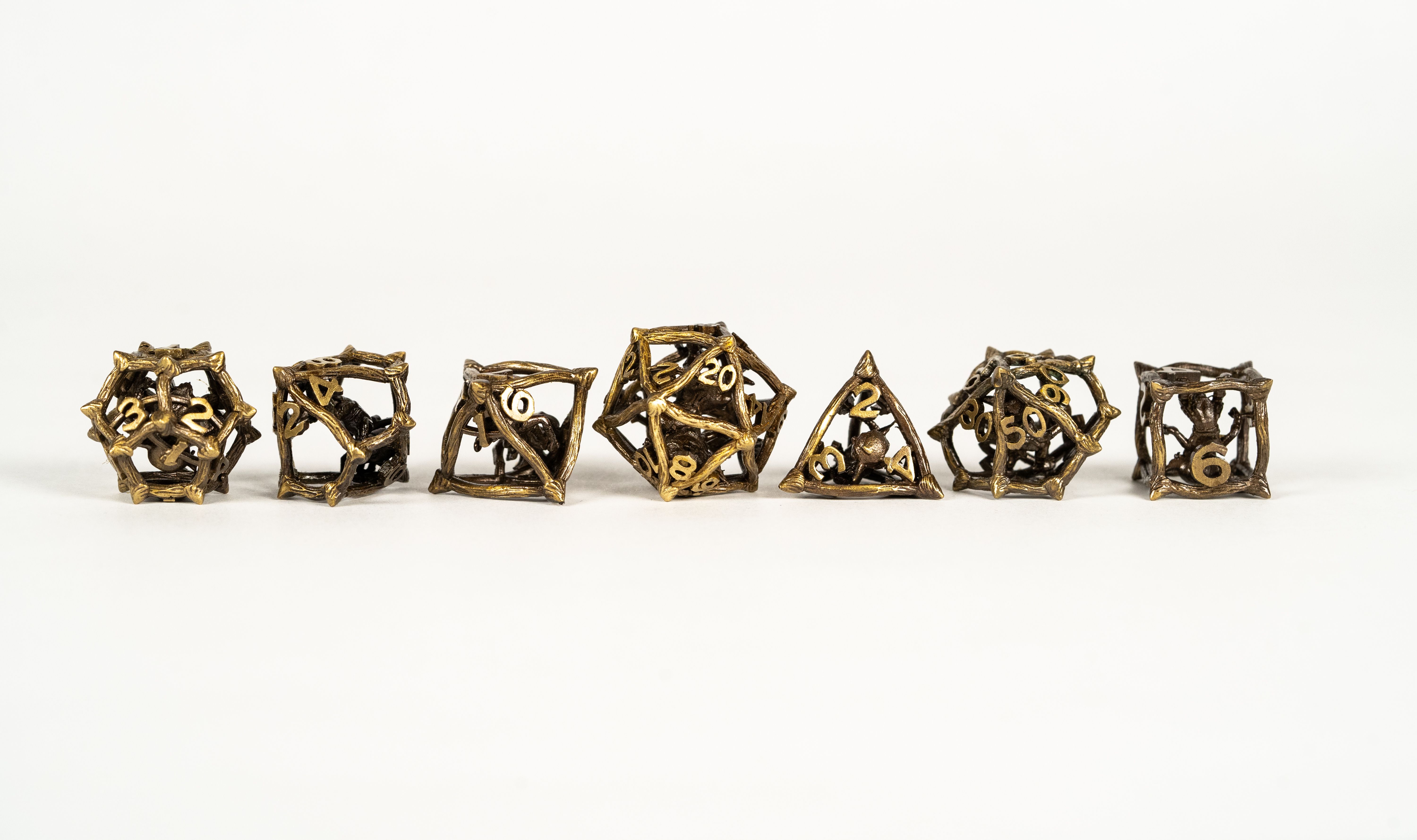 Metal cage dice with little goblins in the center