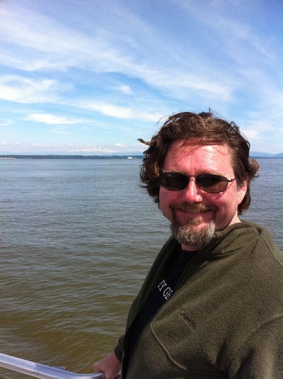 Photo of Gary Teter leaning against a boat railing