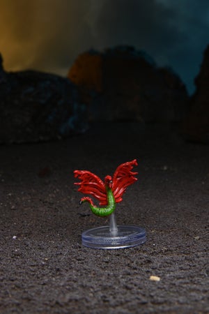mini figure of an Electrovore, a small eel-like alien with red wings and green body