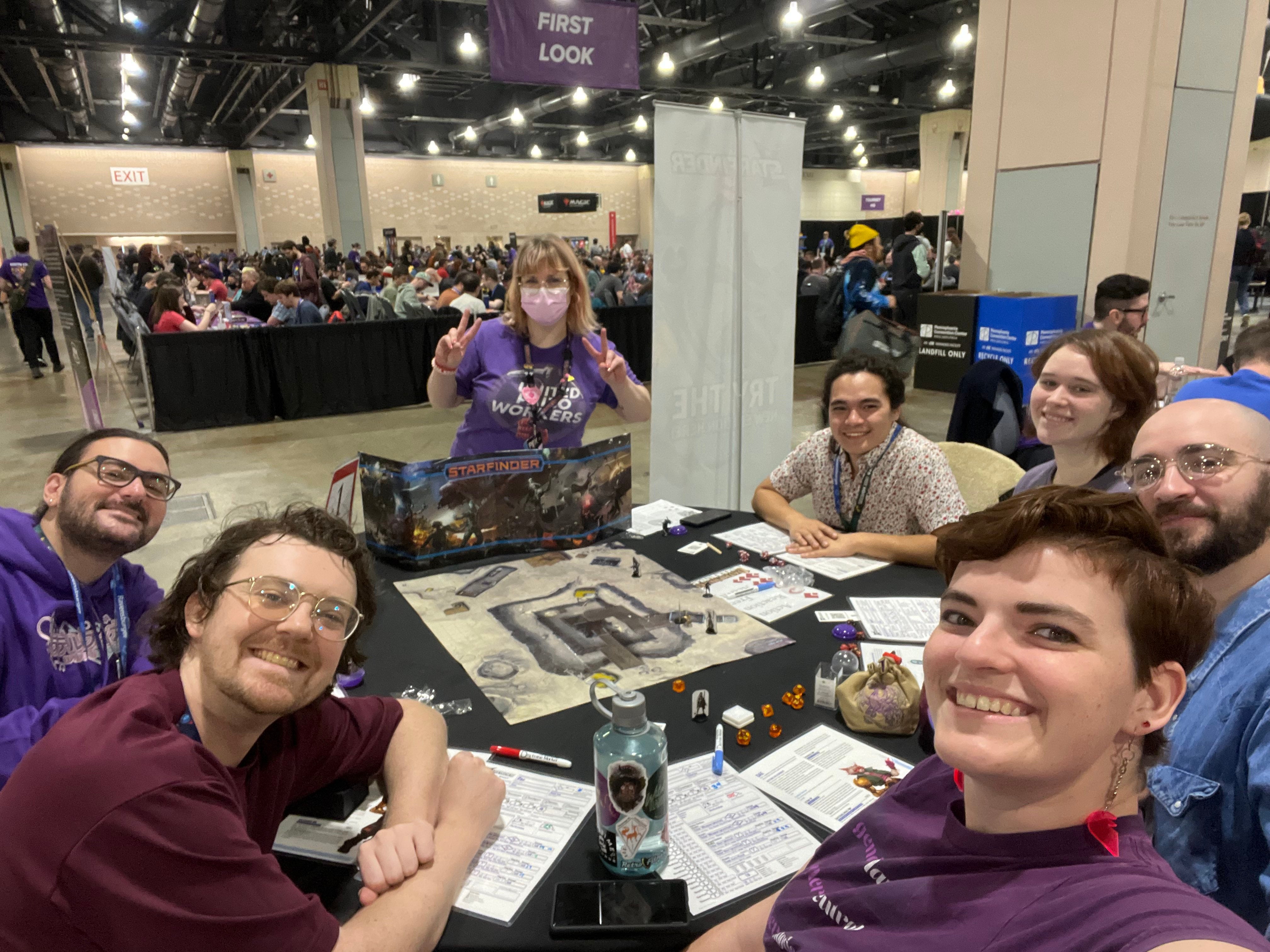 A group of players sitting around a table at the PAX unplugged convention