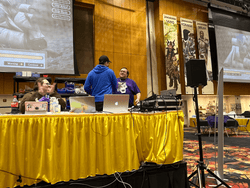 Organized Play Coordinator, Alex Speidel shaking hands with a volunteer