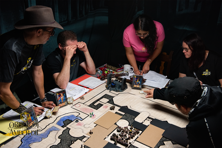 The Order of the Amber Die all standing around the table