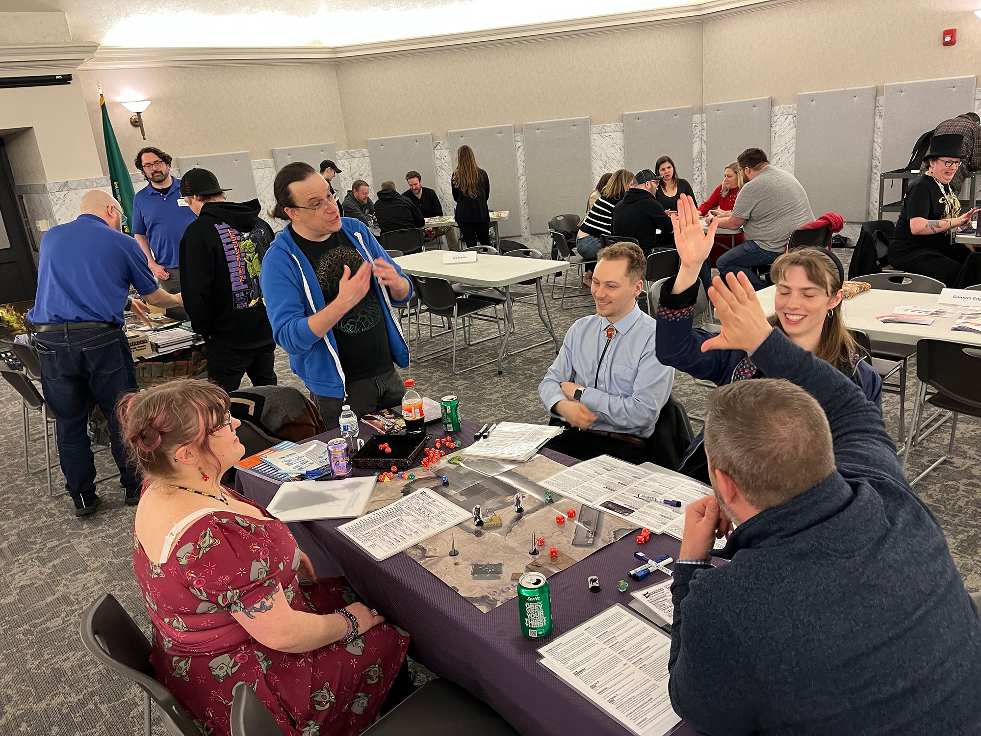 Lead developer John Compton runs Legislative Game Day participants through a round of Starfinder while, in the background, Pathfinder lead designer Logan Bonner and Director of Sales Cosmo Eisele demo Pathfinder.