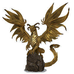 a mini figure of a golden dragon rearing back on a large stone with its wings spread