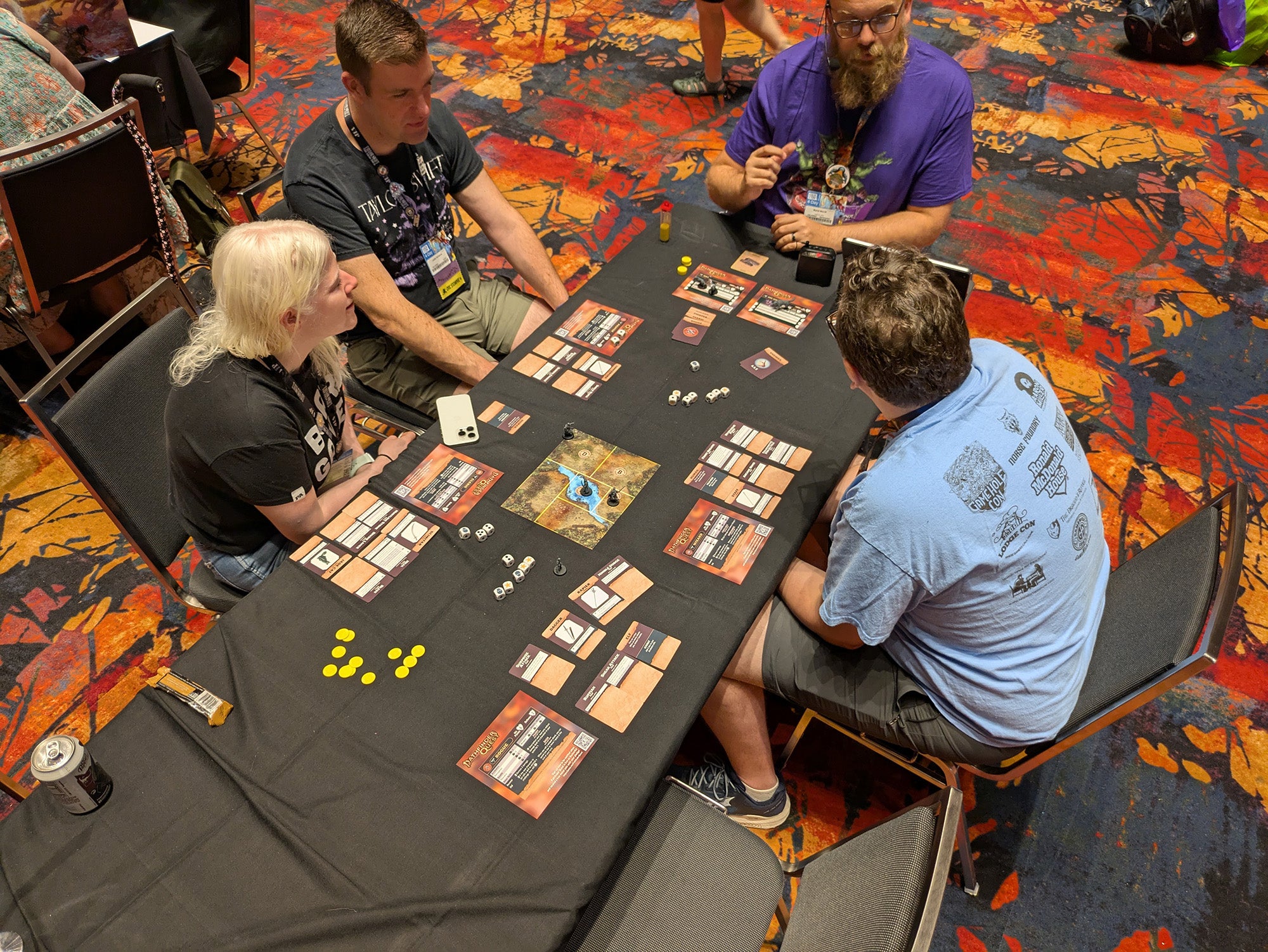 A photo of a group of players playing the Pathfinder Quest Board and card game. 