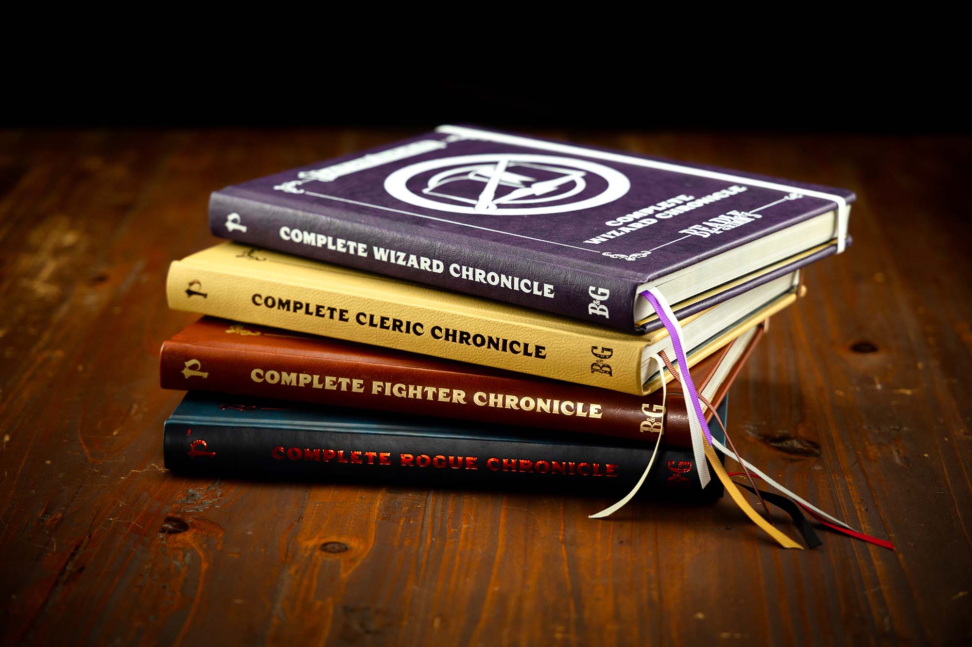 Beadle and Grimm's character chronicles books stacked up on a wooden table