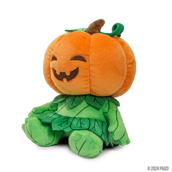 A gourd leshy plushy with a jack-o-lantern shaped head and a leafy green body
